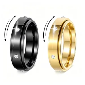 Detail of gold and black spinner rings with inlaid crystals and rotating mechanism