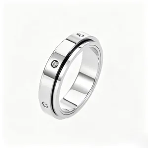 Polished silver spinner ring with a sleek black line and inset cubic zirconia stones