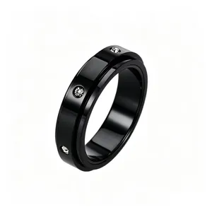 Detail of black spinner ring with embedded cubic zirconia stones on polished steel
