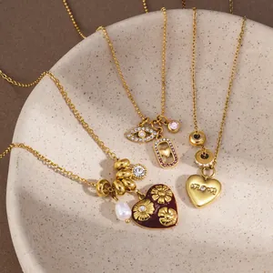 Detailed view of gold stainless steel necklaces with mama heart and floral heart charms