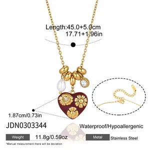 Detailed view of the stainless steel heart necklace with floral patterns and pearl charm
