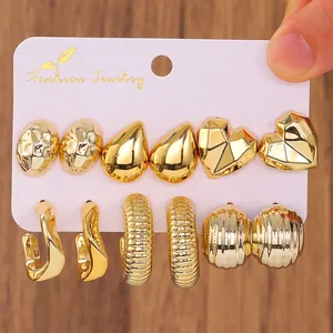 Detail of 6-pair gold C-shape earring set with heart and waterdrop geometric designs