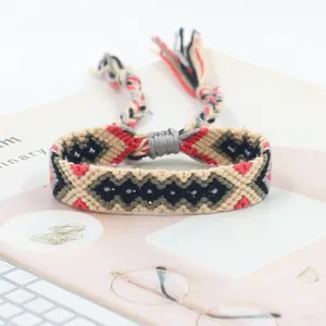Handmade woven friendship bracelet with ethnic geometric patterns and colorful tassels