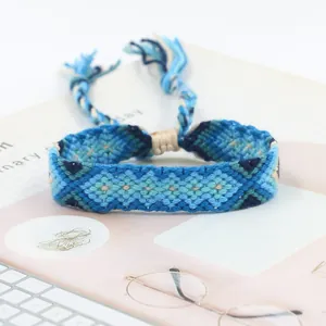 Macro shot of blue hand-woven friendship bracelet with ethnic geometric patterns