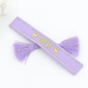 Handmade purple woven bracelet with gold NICE embroidery, heart patterns and tassels