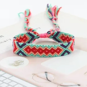 Detail view of woven friendship bracelet with geometric patterns and tassel ties