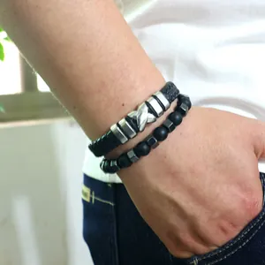 Nahaufnahme von schwarzem Lederarmband und matten Perlen am Handgelenk für Herren