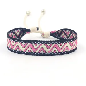 Ethnic bohemian woven bracelet with pink geometric jacquard pattern and adjustable cord