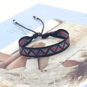 Macro detail of Bohemian woven bracelet with geometric patterns and adjustable cord