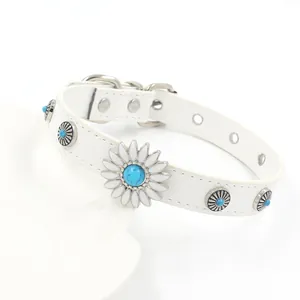 Detail of white leather choker featuring turquoise rivets and daisy flower ornament