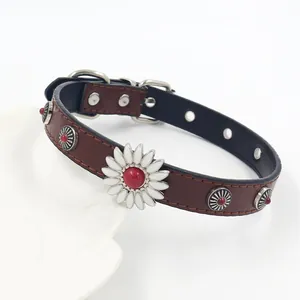Close-up of leather choker featuring white daisy floral charm and vintage metal studs