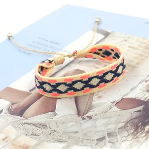 Detail of bohemian woven bracelet with geometric diamond pattern and adjustable drawstring
