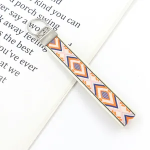 Macro shot of ethnic geometric embroidery pattern on lanyard with silver metal clip