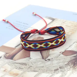Close-up of bohemian woven bracelet with colorful geometric diamond pattern and adjustable cord
