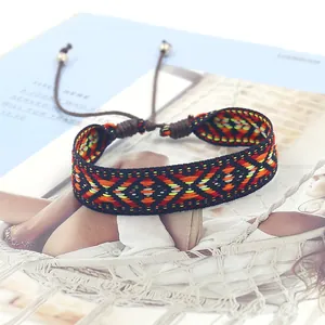 Macro shot of Bohemian woven bracelet with colorful geometric diamond patterns and beads