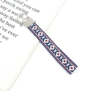 Close-up of bohemian embroidered wristlet keychain with blue and red geometric pattern