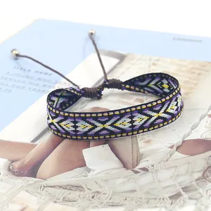 Detailed view of woven geometric tribal bracelet with purple and yellow patterns