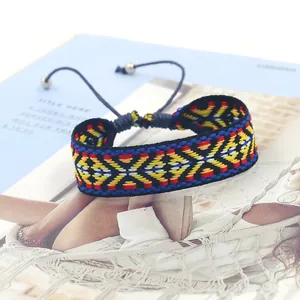 Detail of bohemian geometric woven bracelet with adjustable cord and silver bead charms