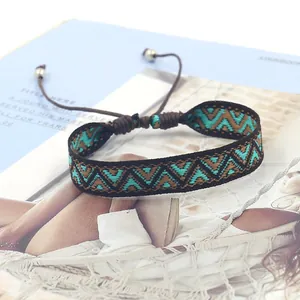 Detailed close-up of Bohemian woven bracelet with geometric patterns and adjustable cord