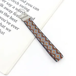 Close-up of ethnic embroidered wrist strap keychain with geometric diamond patterns