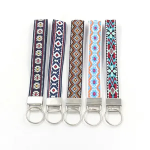 Close-up of five colorful ethnic embroidered lanyards with silver metal clasps and rings