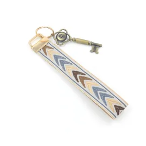 Ethnic style embroidered lanyard keychain with geometric V-pattern and bronze key charm