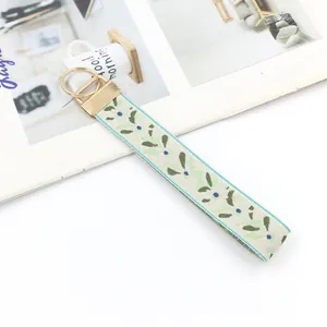 Ethnic style embroidered vine leaf wristlet keychain with elegant gold metal hardware