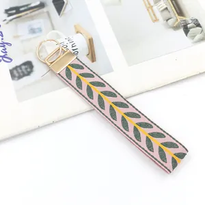 Ethnic embroidery leaf wristlet keychain with pink fabric strap and gold hardware