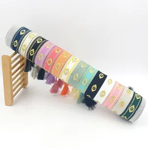 Colorful woven evil eye bracelets with gold embroidery and decorative tassels