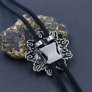 Vintage sunburst bolo tie with antique silver slider and black braided cord