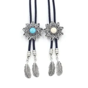 Detail of Western bolo ties with turquoise inlay and silver feather charms on black cords