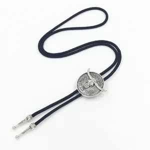 Vintage western bull head bolo tie with silver metal relief on a black braided cord