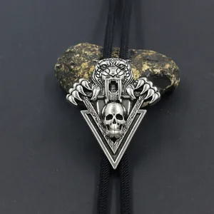 Vintage bolo tie with silver sabertooth tiger and skull pendant on black cord