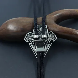 Macro detail of vintage silver-tone Bolo tie metal slide buckle and black braided cord