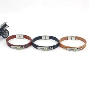 Macro detail of leather feather bracelets with turquoise inlay and stainless steel buckle