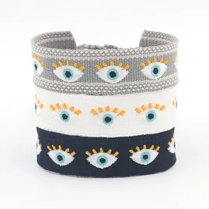 Ethnic embroidered woven tassel bracelets with evil eye patterns in black grey and white