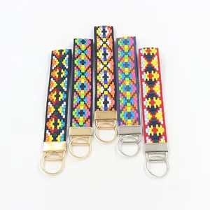 Détail de cinq porte-clés tissés ethniques avec motifs en losange et fermoirs en métal