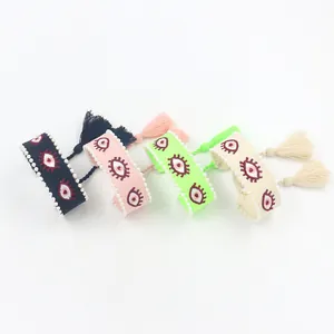 Handmade woven bracelet set with evil eye embroidery, pearls, and tassels in four colors