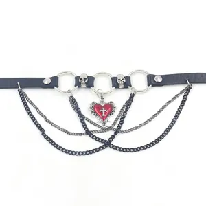 Detail of gothic leather choker featuring silver skulls, red heart pendant, and layered chains