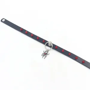 Macro view of punk leather choker with red spikes and silver spider pendant detail