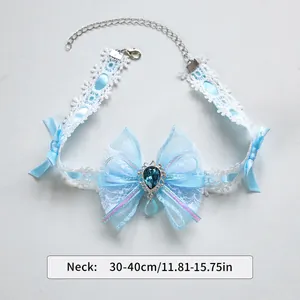 Close-up of blue Lolita lace pet choker with organza bow and crystal drop pendant