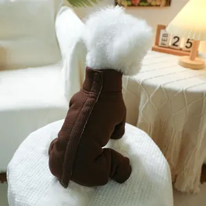 Detailed back view of a small white dog wearing a brown ribbed knit pet onesie at home
