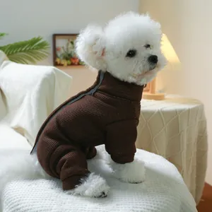 Detail of dark brown ribbed knit pet jumpsuit on white dog in a cozy home setting