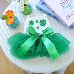 Detail of pet dress with green embroidered clovers, satin bow and rhinestone heart buckle