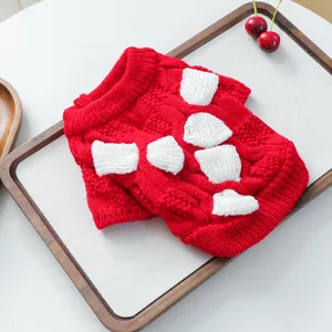Detail of red knit pet sweater with white bone pattern and ribbed cuffs for small dogs