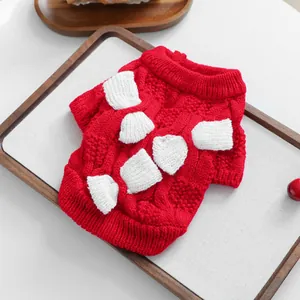 Red festive knit dog sweater with white bone patches and warm cable knit texture