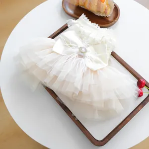 Detail of elegant pet wedding dress with multilayer tulle skirt and rhinestone bow decoration