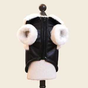 Detail of pet biker jacket with black faux leather texture and plush white fur trim