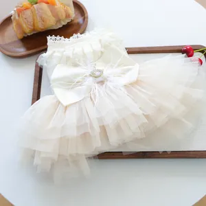 Elegant cream pet princess dress with layered tulle, satin bow and feather accent for small dogs