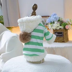 Detail view of green and white striped pet hoodie with white fleece trim and plush brown pompom